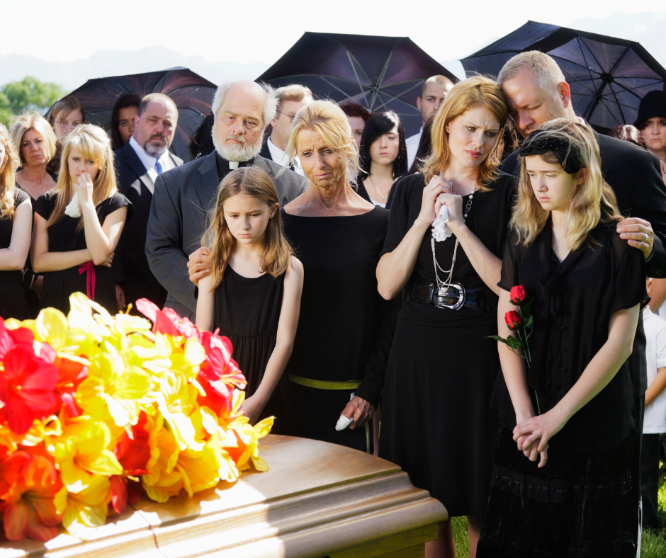 Mourners in black around a coffin at the Graveside